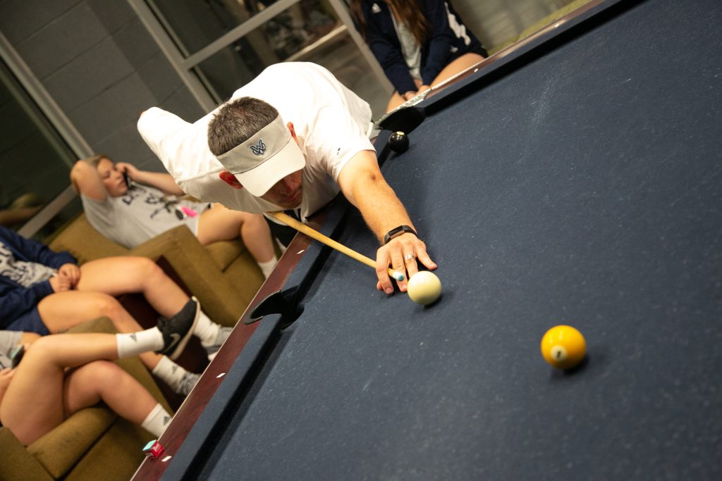 male student plays pool
