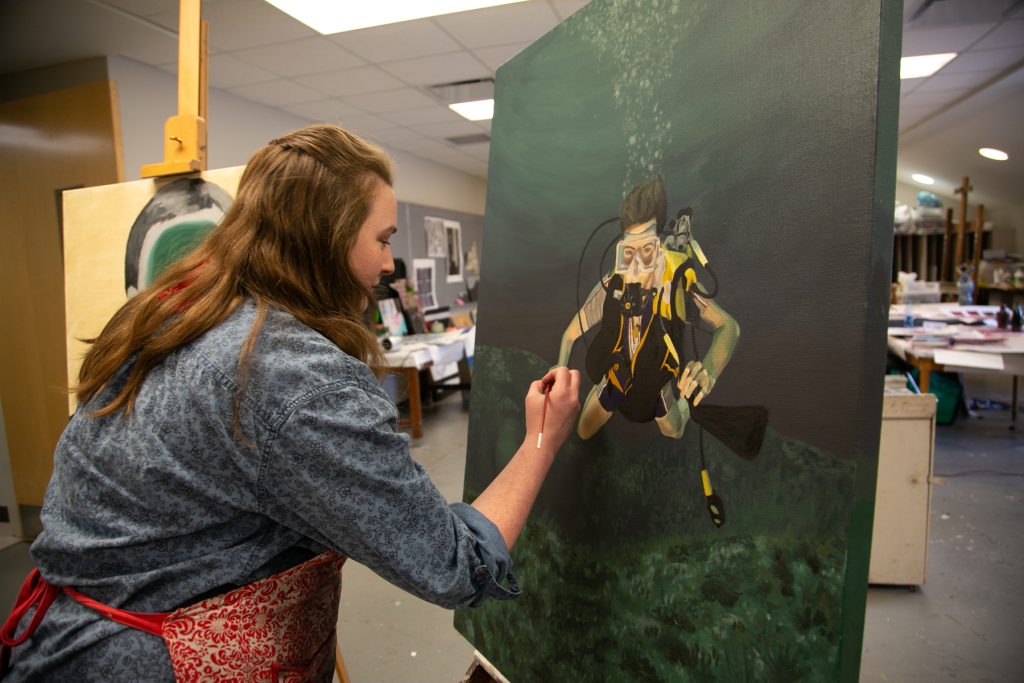 Female student paints in studio
