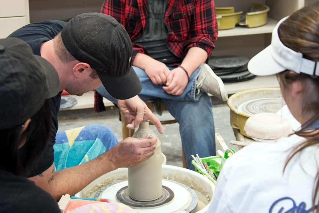 Ceramics professor demonstrates a pottery technique