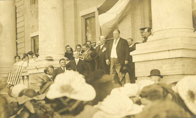 Historic photograph of William Howard Taft and Henry Whitfield standing on the steps of Poindexter Music Hall