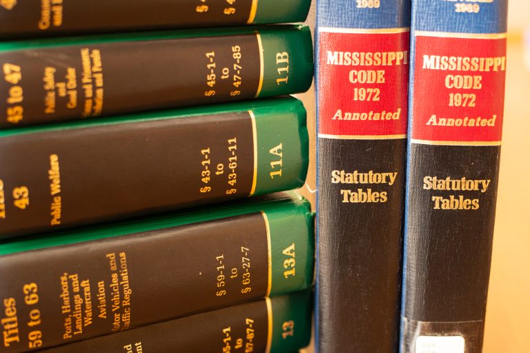 Stack of legal code books on a desk