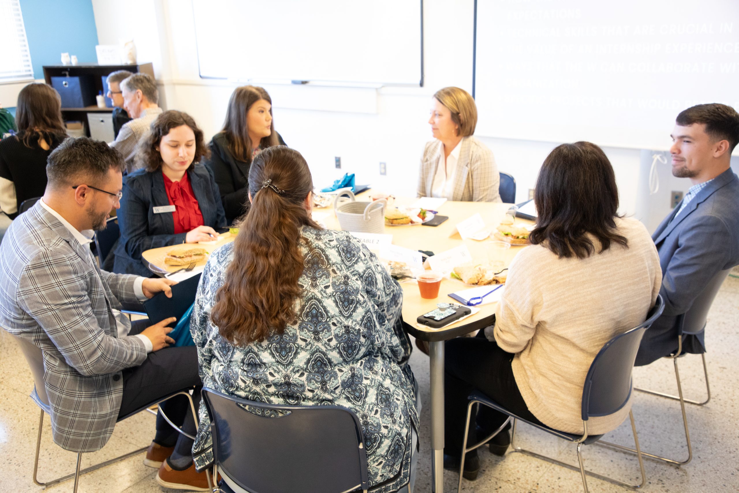 Photo of 3 business reps conversing with 3 MUW faculty and staff