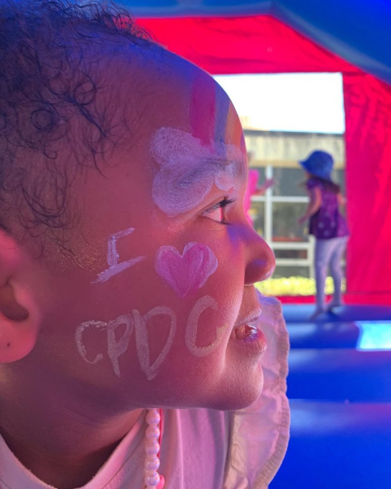 A young student with I Love CPDC painted on her face