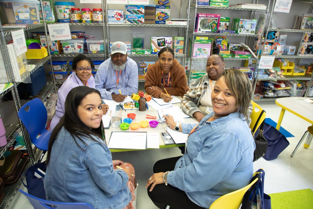 People sitting around a table with worksheets