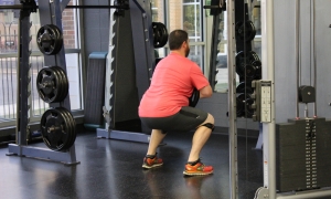 man squatting weights