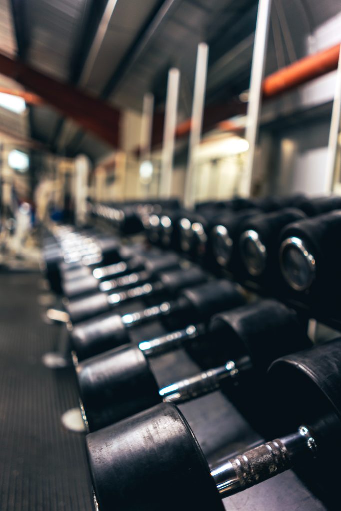 Dumbbells in a weight rack in a fitness center 