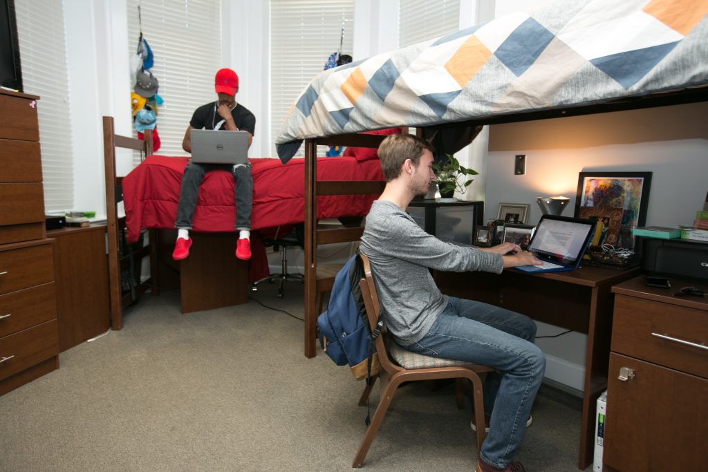 Two men study in residence hall