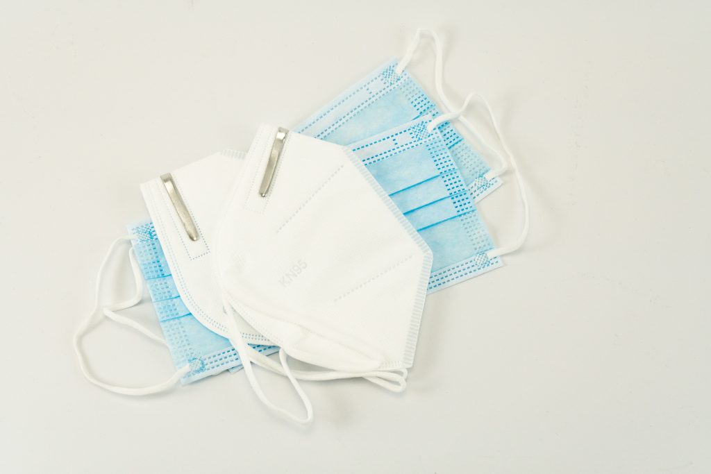 A stack of surgical masks and KN95 masks