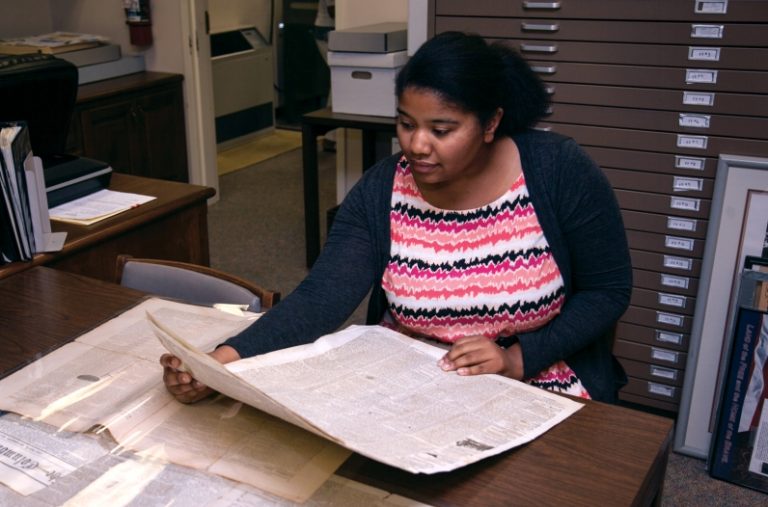 Student reading in archives