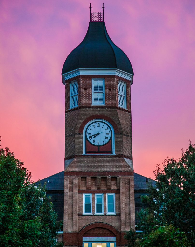 Callaway hall at sunset with a pink and purple sky behind the iconic clocktower