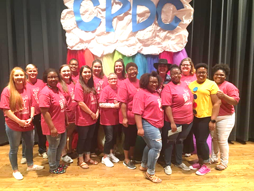 CPDC gather on stage during an event