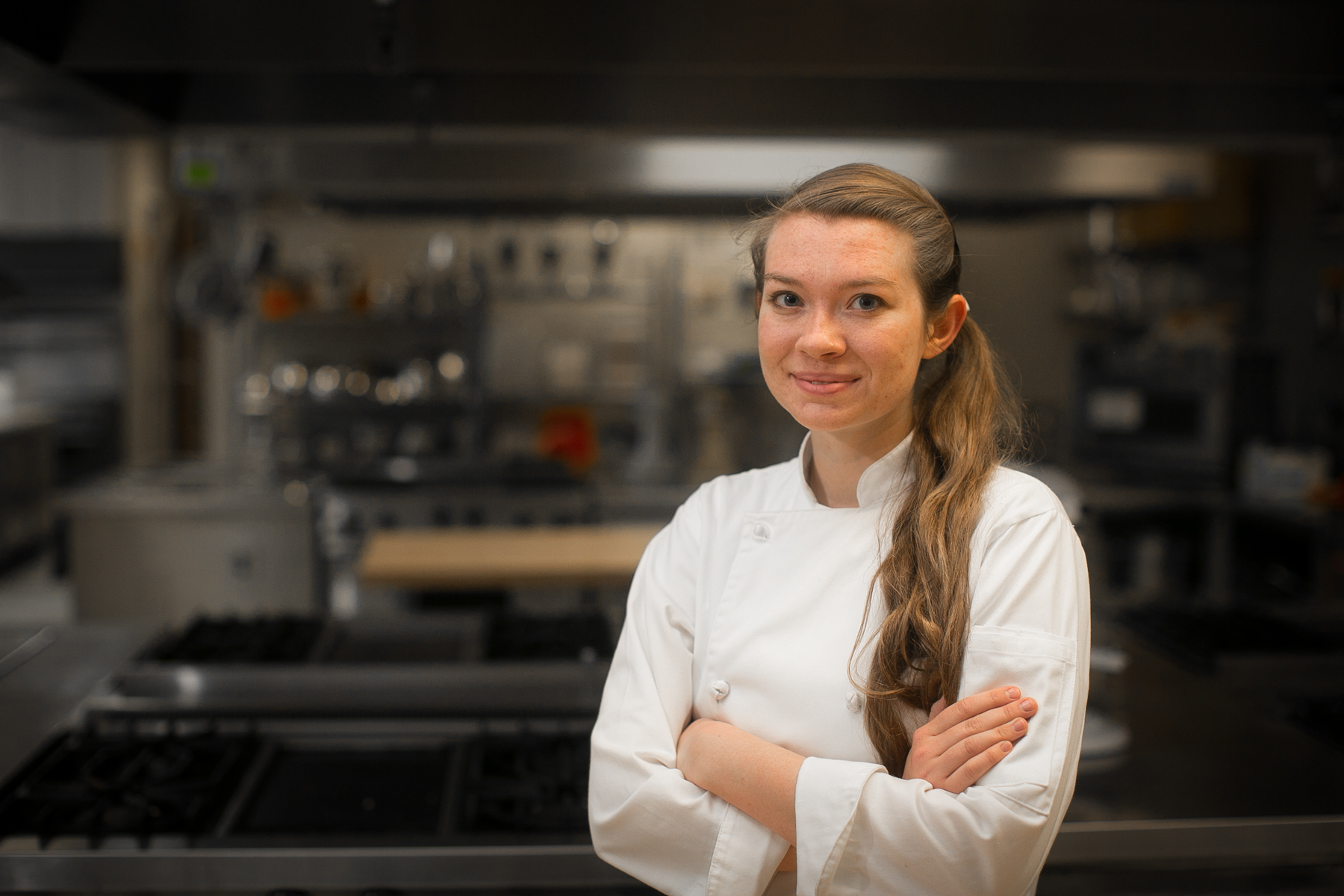 woman in chef jacket in kitchen