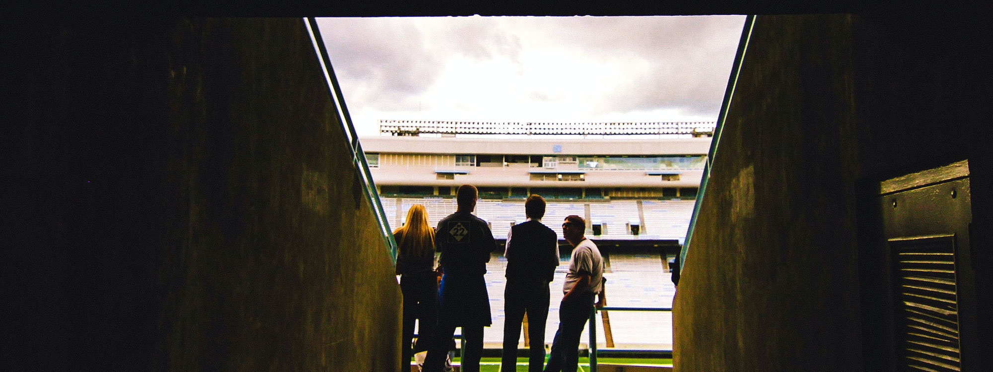 Group of people standing at entrance to a stadium
