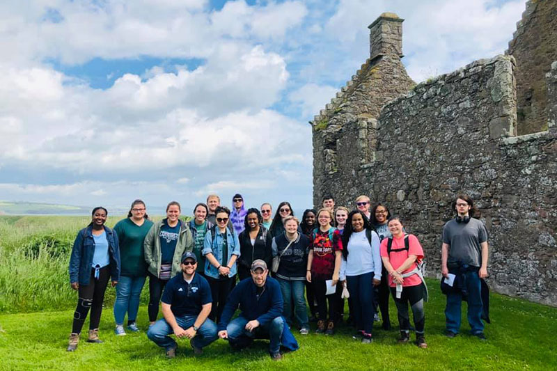 Honors students pose near ruins in Ireland