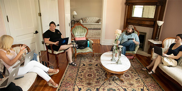 MFA creative writing students discuss a story inside a historic home