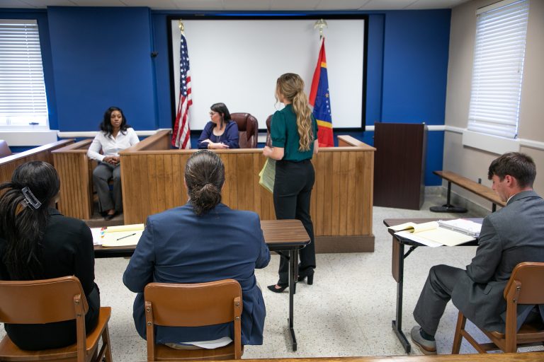 A student witness testifies on the stand during a mock trial