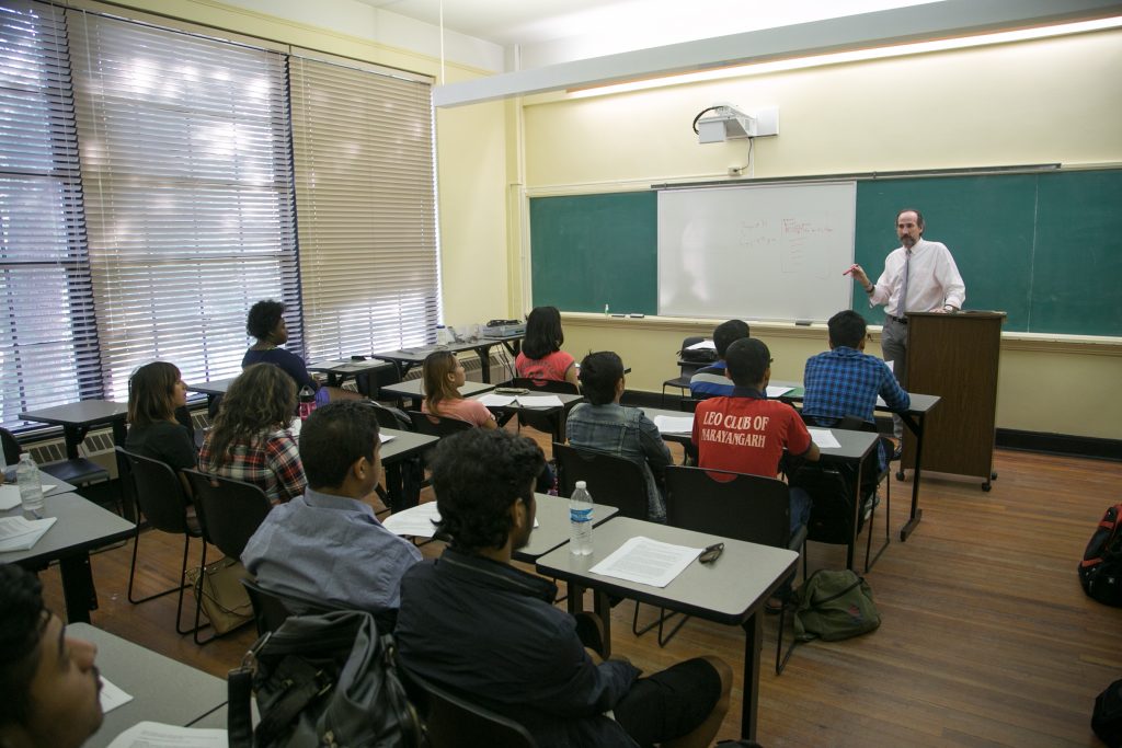 Students in classroom listen to professor