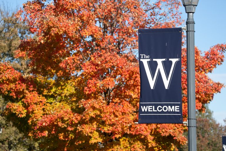 The W banner in front of autumn trees