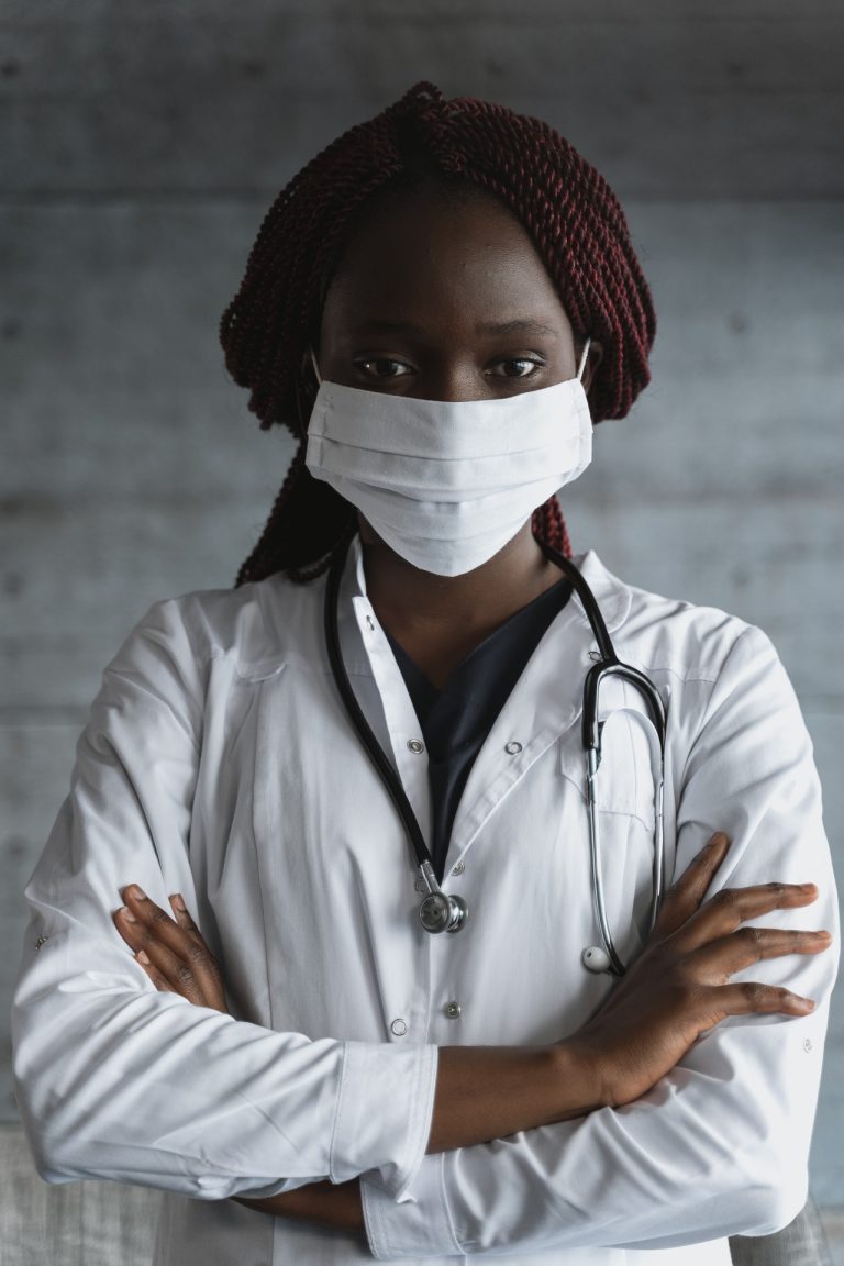 Women in lab coat with mask on