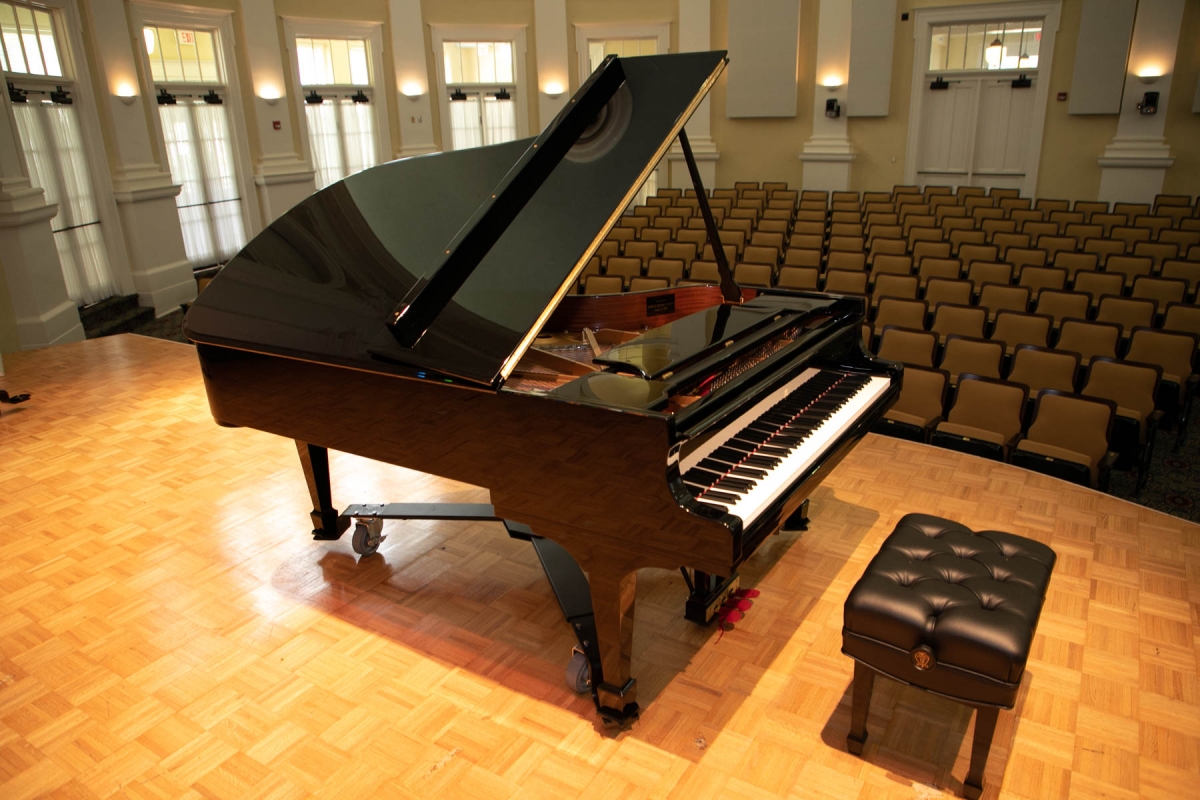 Grand piano on a stage in an empty auditorium