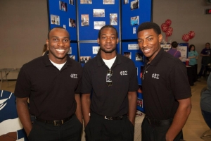 three men wearing fraternity shirts