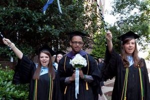 Two women and a man in graduation attire