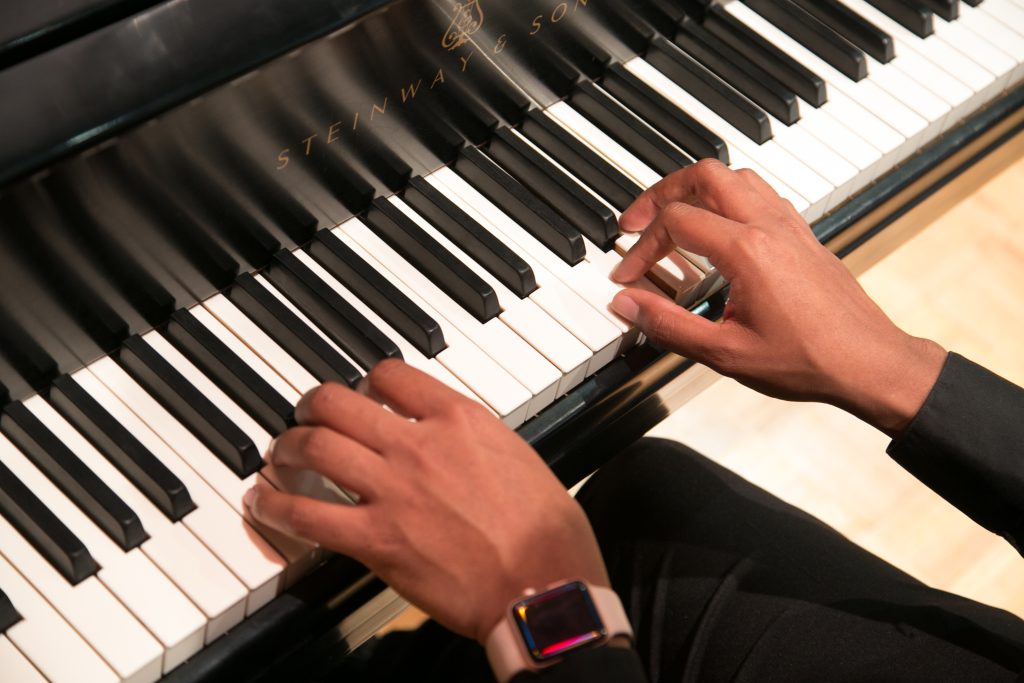 Close up of hands playing a piano