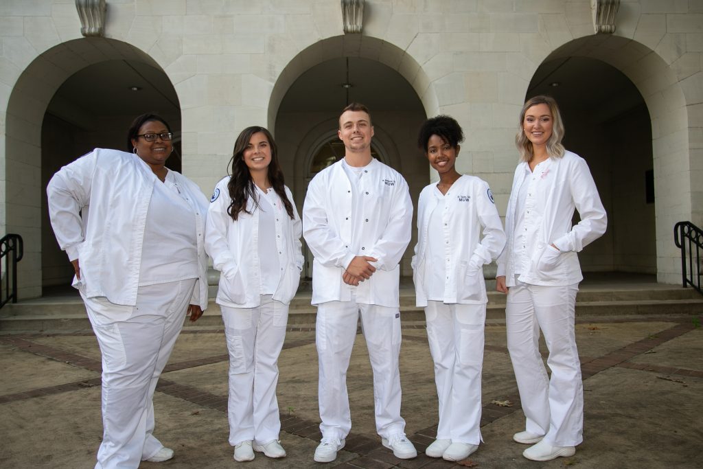Five student nurses standing outdoors