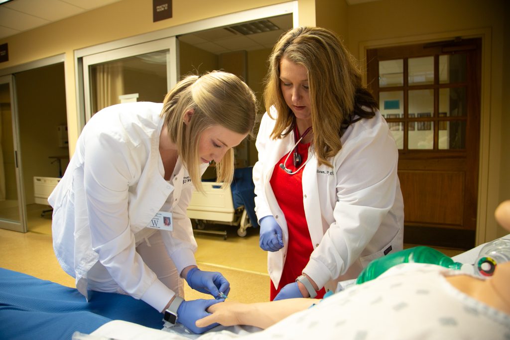 Nursing instructor directs a student