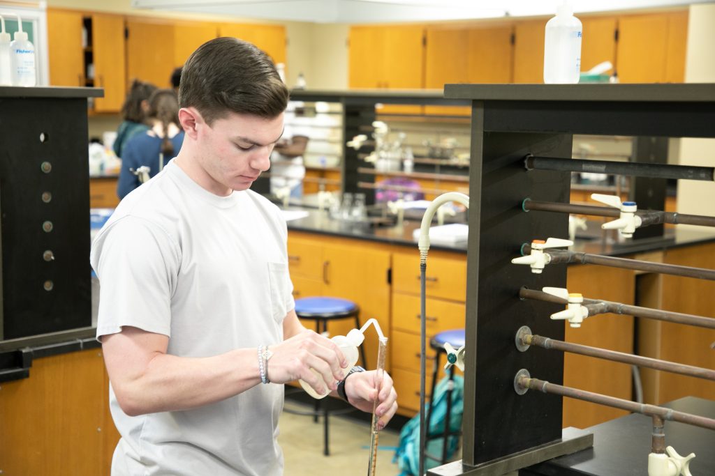 Student works on a sample in a chemistry lab