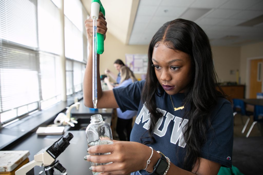Student works on a sample in a biology lab