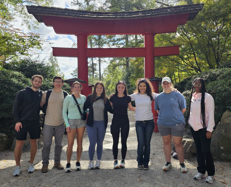 Students on a field trip standing under a pergola