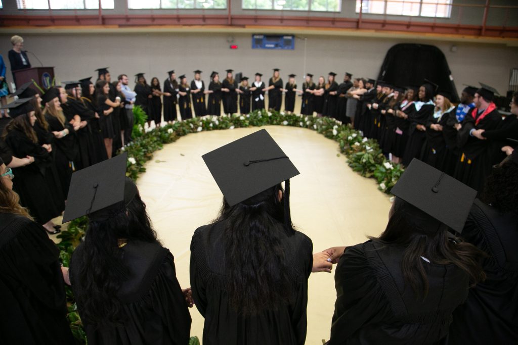 Students hold hands during Mag Chain ceremony