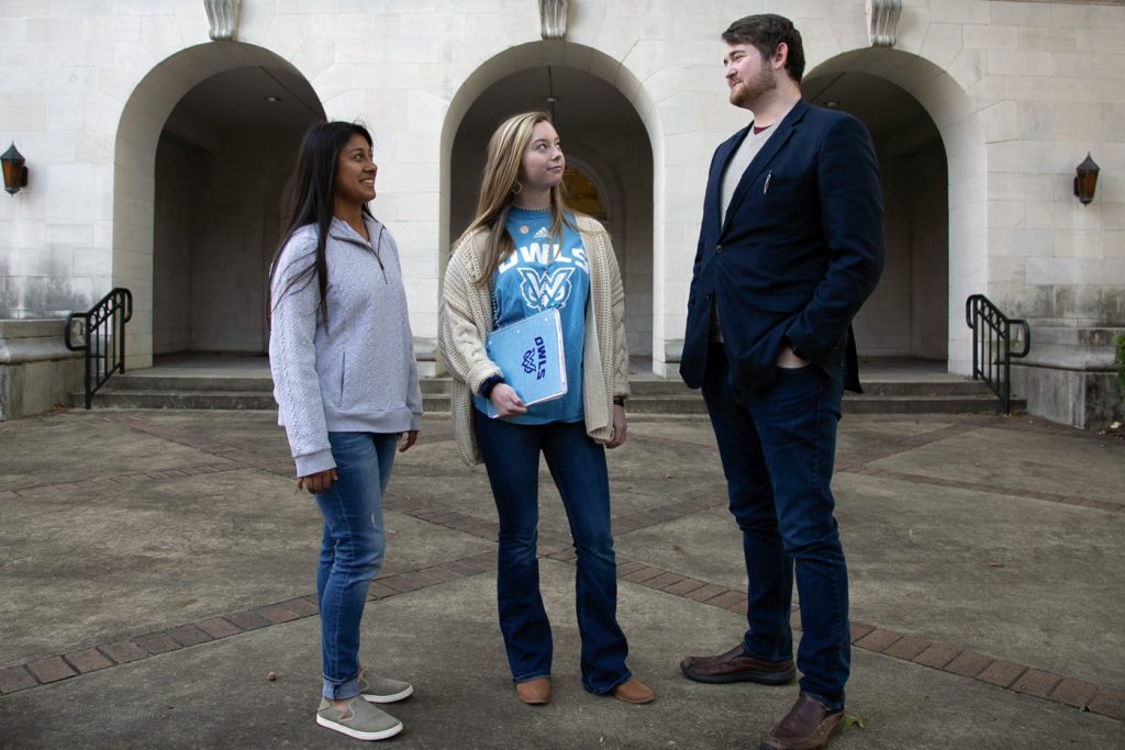 SGA president talks with two students outside