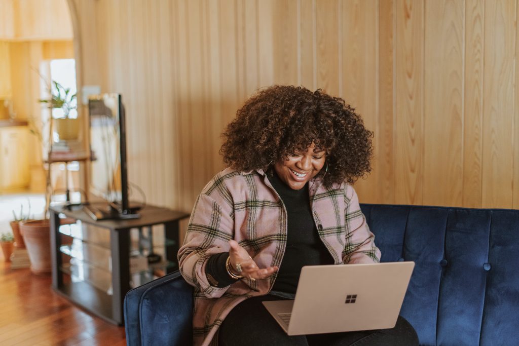 Woman chatting on laptop in house