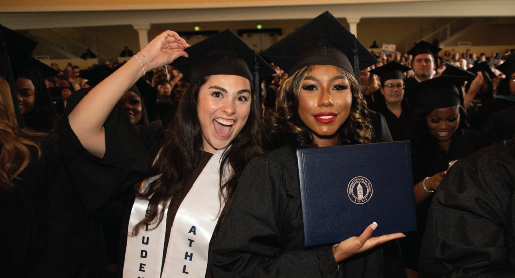 Two students in graduation garb