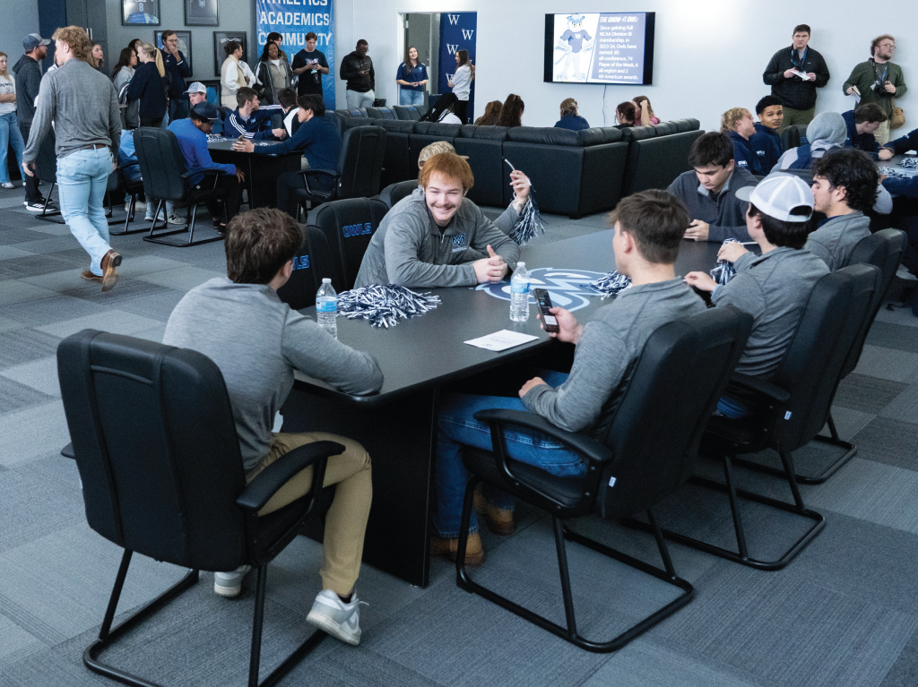 Six student-athletes sitting around a table.