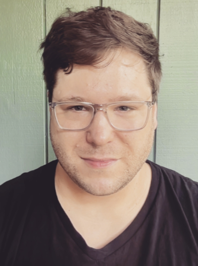 White man with glasses and black t-shirt