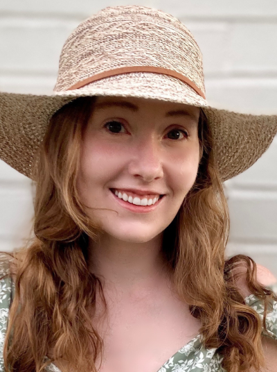 White woman with blond hair wearing straw hat