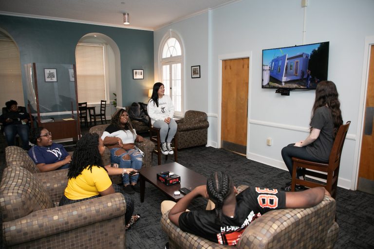 Students watching TV in a rec room.