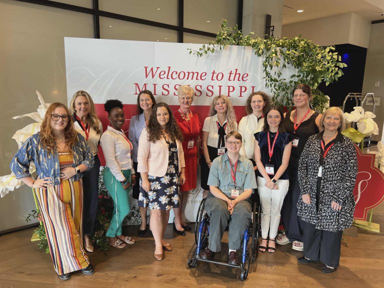 A group of people posing for a photo at the Mississippi Women's Summit