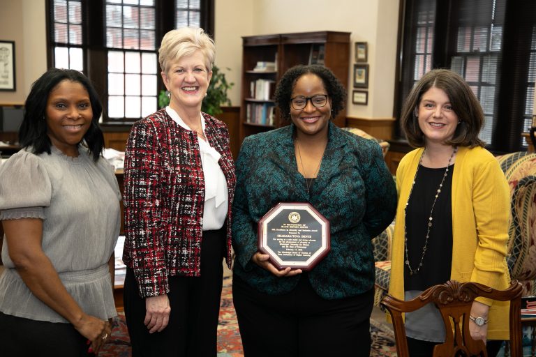 Dr. Shahara'Tova Dente receives the Diversity Educator of the Year award from the President and the chairs of the DEI council.
