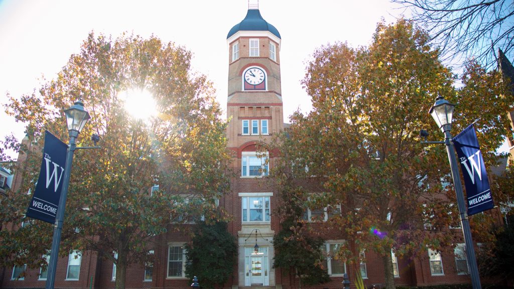 Front view of Callaway Hall with sun shining through trees