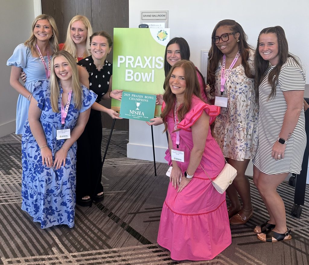 Members of The W's Praxis Bowl team pose with their award for winning the competition.