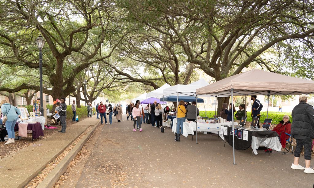 People browse the offerings from the vendors at the Under the Oaks arts festival on The W's campus