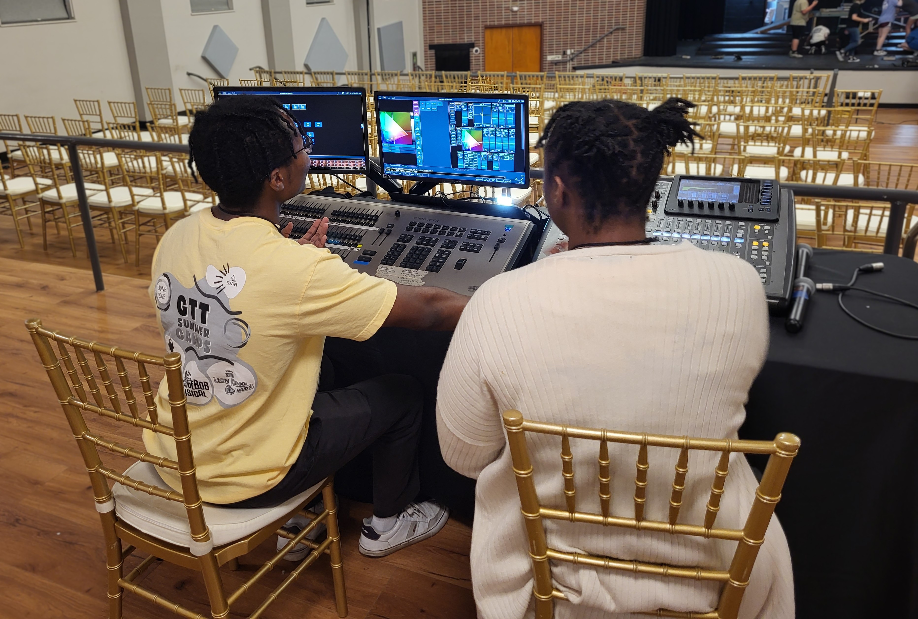 Nancy Yates Fellows work on the stage lighting controls