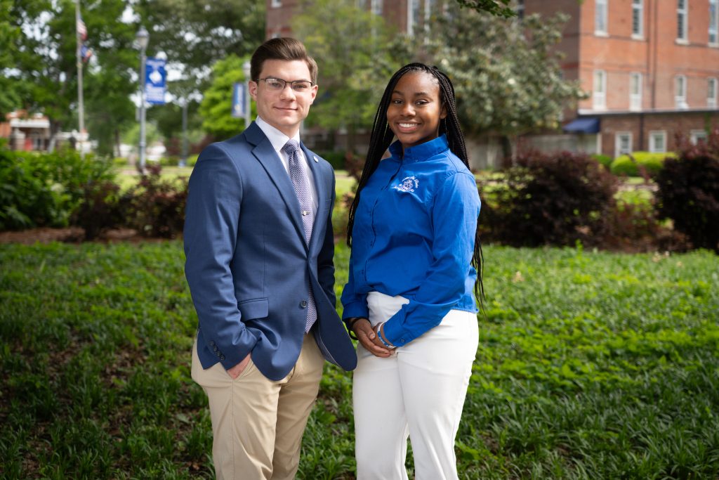 Ethan Wilkins and Sasha Burdine stand outside on The W's campus.