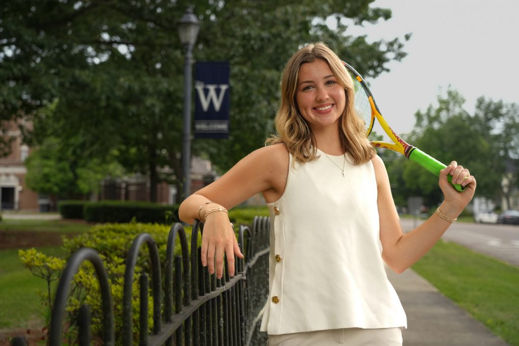 Emma Horton poses for picture holding a tennis racket.