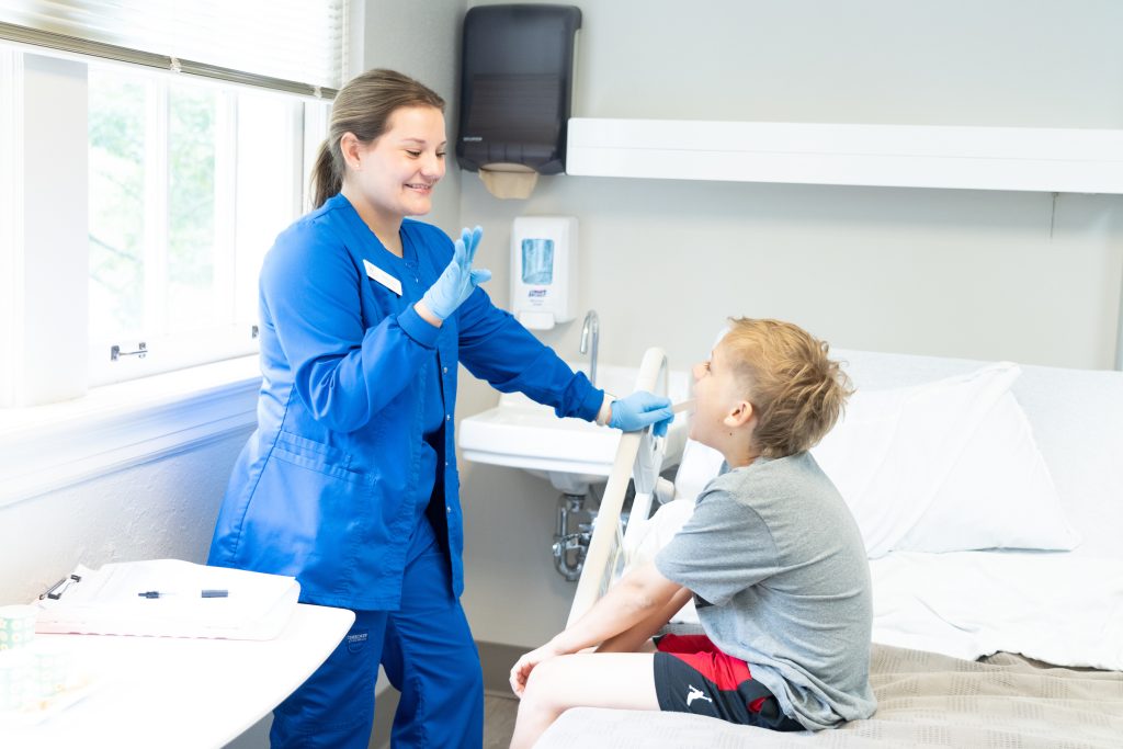 SLP student examines a child