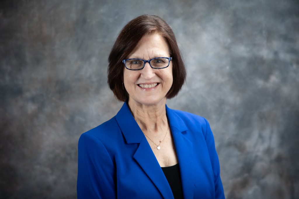 Dr. Kim Whitehead in front of a backdrop
